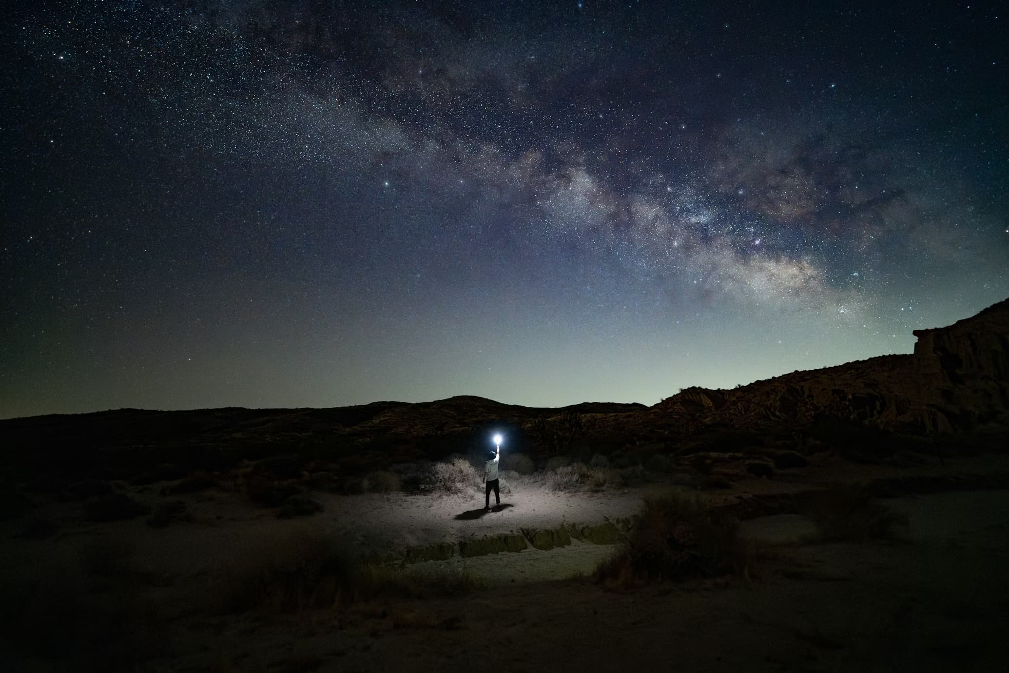 A solitary figure beneath the Milky Way